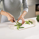 Chopping board with integrated knife for vegetables